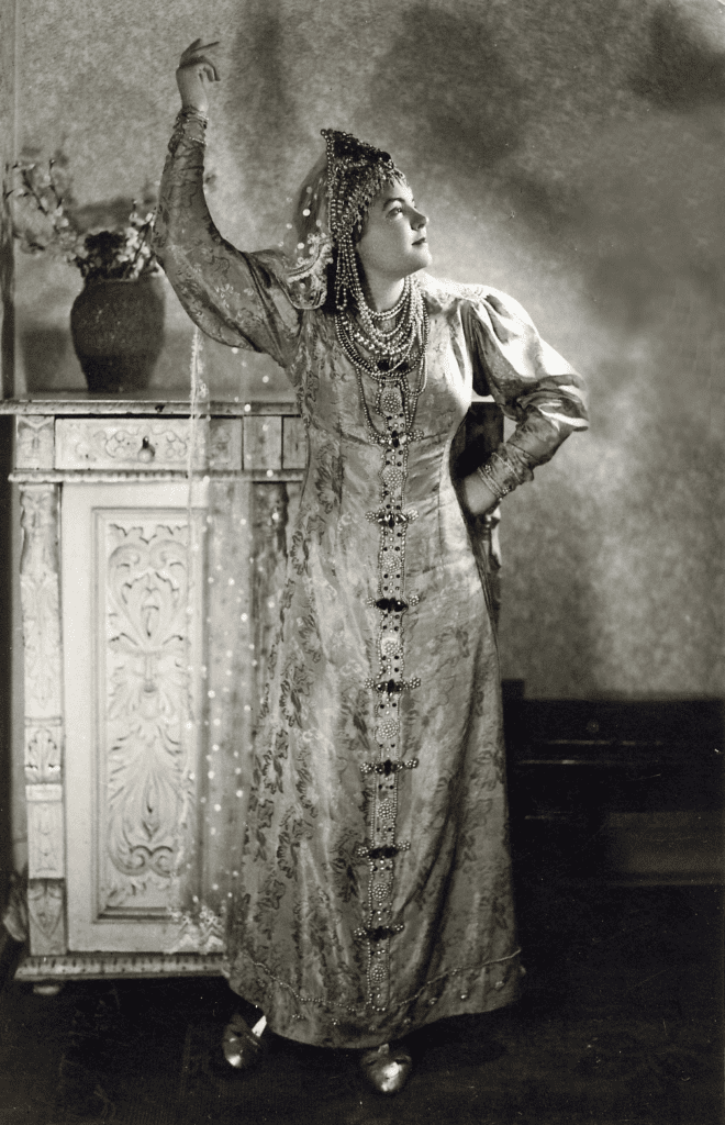 Young Russian woman wearing full court dress of Russian boyarina. Fancy brocade dress and jeweled headdress.