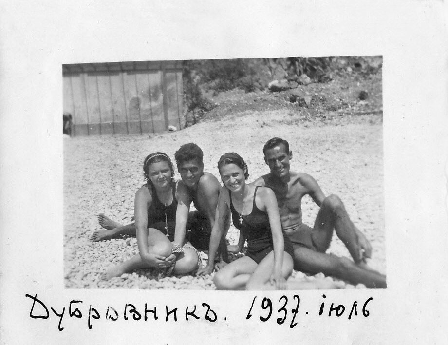 Old photo of two young women and two young men wearing bathing suits on a beach in nineteen thirty-seven.