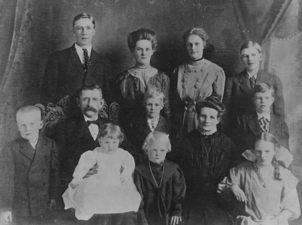 A family in 1909 in their Sunday best clothes. There are seven boys and three girls plus the mother and father.